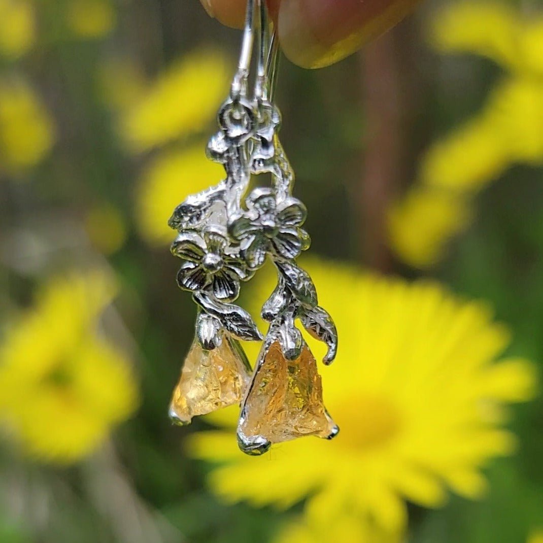 silver flower and citrine dangle earrings pictured in garden