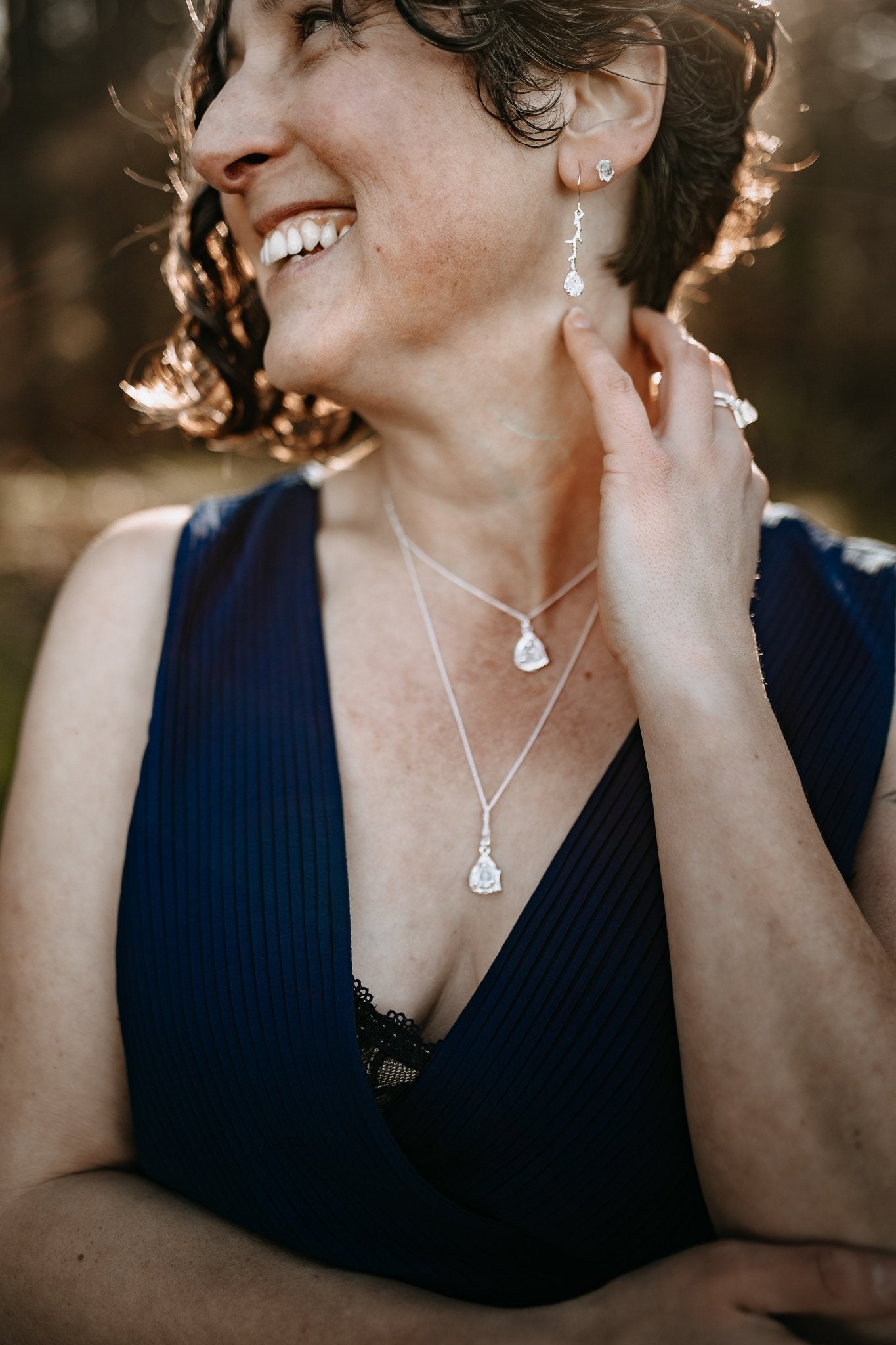 model wearing Herkimer diamond silver branch earrings with matching pendant necklaces and studs