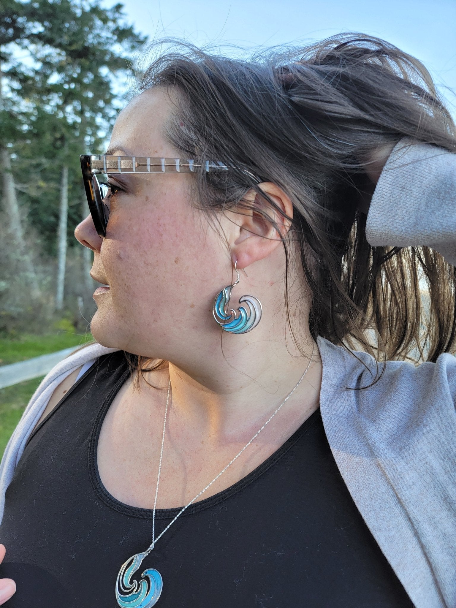 blue Rip Curl Resin and Silver Ocean Surf Wave Earrings on model with matching blue ocean wave necklace