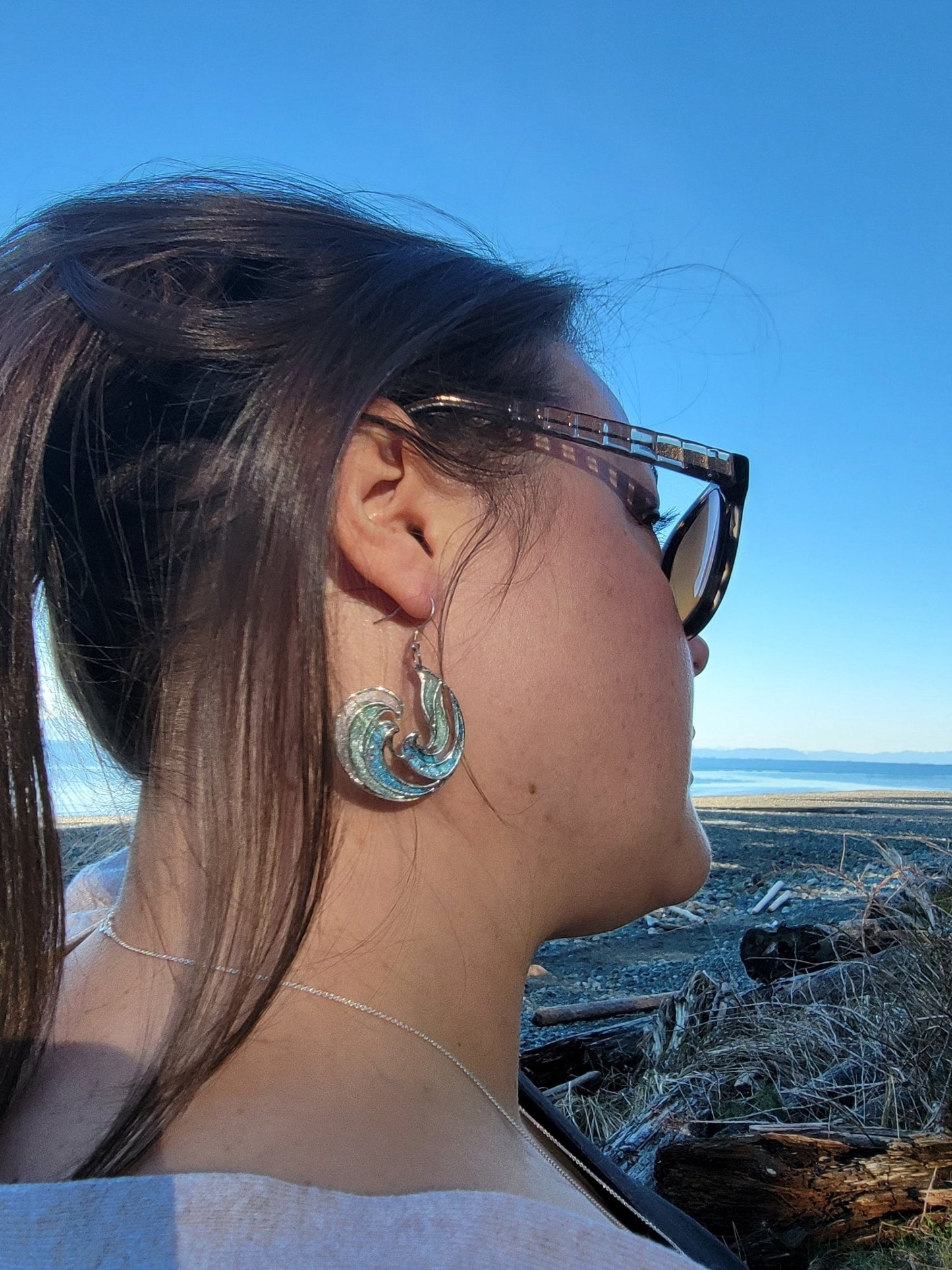 blue Rip Curl Resin and Silver Ocean Surf Wave Earrings on model at beach