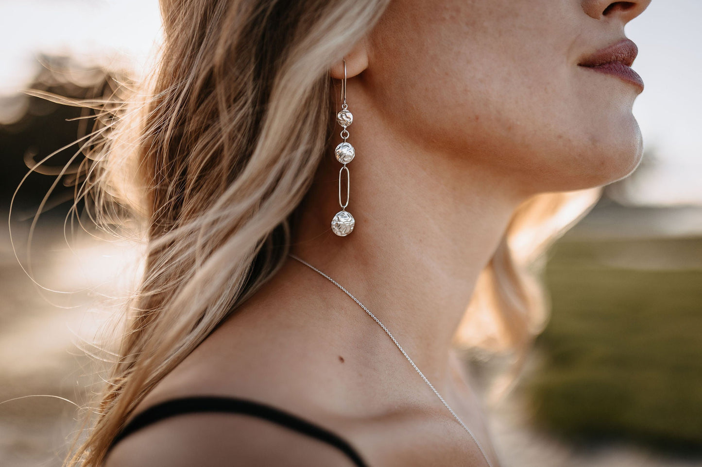 close up of model wearing silver driftwood textured lightweight chandelier statement earrings 